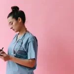 Healthcare worker writing on a clipboard