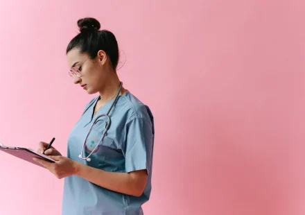 Healthcare worker writing on a clipboard