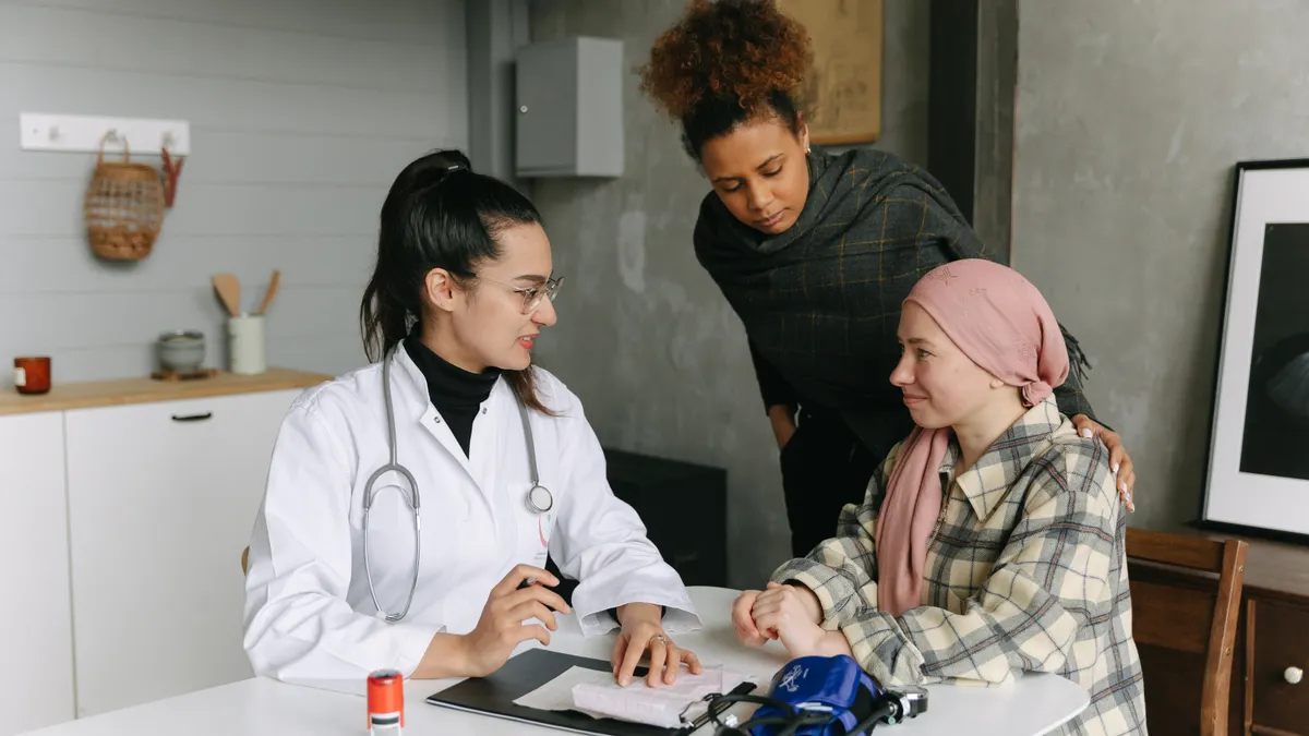 Caregiver intake questions: what to ask before taking on a new care role Doctor taking intake notes with patient and companion