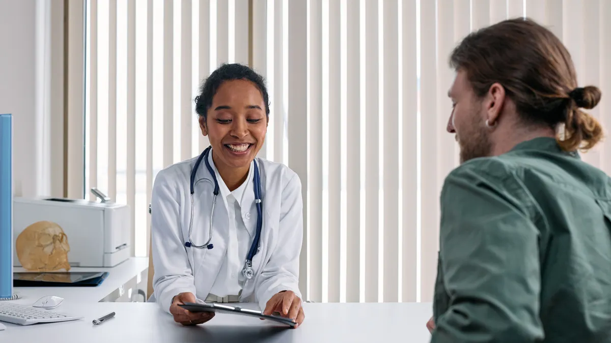 Caregiver intake questions: what to ask before taking on a new care role Doctor interviewing a patient at a desk
