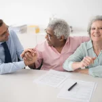 Older adults discussing care plans at a table