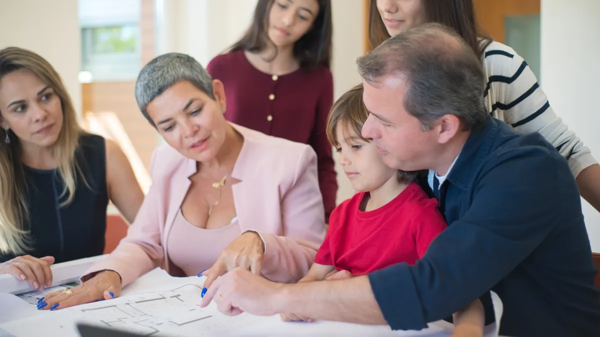 Caregiver planning and coordination — The Complete Guide Family reviewing a care plan on paper