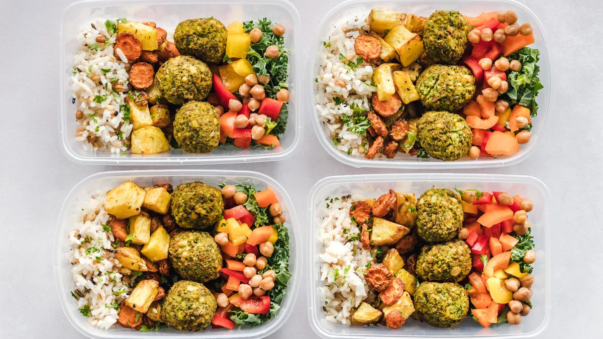 Meal-prep boxes with rice, vegetables, and protein portions